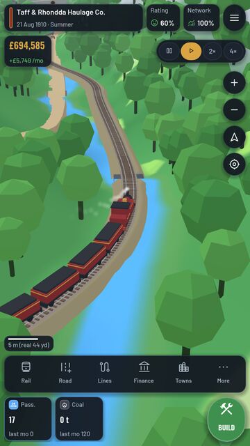 A coal train on the Taff Vale line, between wooded hills and the river.